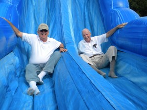 Dr. Don Zeyl (left), a former board member with Doug Brush at WBCA’s 30th Anniversary Event in 2011 - Doug was always a kid at heart, and you can see a bit of that shining through as he takes a ride down the inflatable slide. 
