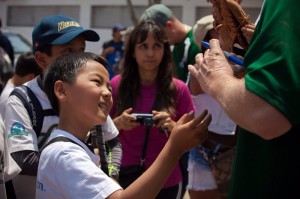 Caption 1: A young Nikkei player from the Peruvian baseball federation waits for the ink to dry after obtaining former big leaguer Tommy Phelps' autograph on his baseball. Nikkei are Japanese emigrants and their descendants. Peru is home to about 100,000 Nikkei, only about 100 of them evangelical Christians.