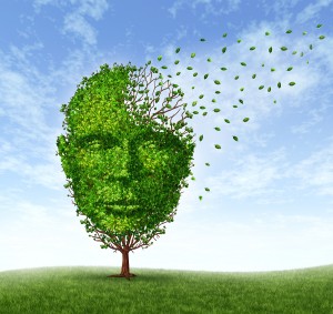 Human dementia problems as memory loss due to age and Alzheimer's disease with the medical icon of a tree in the shape of a front face human head and brain losing leaves as thoughts and mind function fade away.