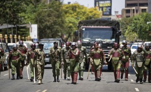 Kenyan riot police firing tear gas charge towards a small group of opposition supporters protesting over the upcoming elections in downtown Nairobi, Kenya Monday, Oct. 16, 2017. Two international human rights groups said Monday that Kenya's police in August attacked opposition supporters killing dozens and injuring scores following demonstrations protesting President Uhuru Kenyatta's subsequently annulled re-election. (AP Photo/Ben Curtis)