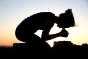 Silhouette of a Young Woman Praying