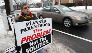 Pro-life advocate Patricia Bankeser of St. Joseph Parish in Kings Park, N.Y., holds a placard near the entrance to a Planned Parenthood center in Smithtown, N.Y., Jan. 19. (CNS photo/Gregory A. Shemitz) (Feb. 8, 2011) 