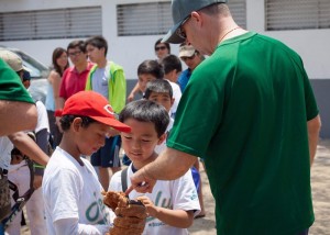 Caption2: Kevin Ohmé, former pitcher for the St. Louis Cardinals, takes time out to talk with some young Japanese-Peruvian baseball fans in Lima, Peru. Ohmé, from First Baptist Church, Brandon, Florida, has traveled to Lima for the past five years to participate in annual baseball clinics, where players hear the gospel while improving their baseball techniques. Photo by Lina White/IMB