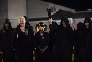 Members of the Seattle chapter of the Satanic Temple wave to yelling students outside of the gates at Memorial Stadium in Bremerton during a football game between the Bremerton Knights and the Sequim Wolves on Thursday, Oct. 29, 2015. Bremerton assistant football coach Joe Kennedy was placed on administrative leave on Wednesday following his decision to pray on the field after he was told not to by the school district. The Satanic Temple of Seattle announced this week that they planned to be at the game on Thursday after a 12th-grader at Bremerton High School had requested the group perform a satanic invocation.