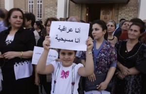Iraqi girl holds a sign: 'I am Iraqi. I am a Christian.'