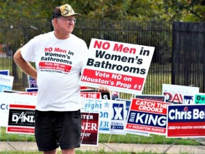 File - In this Oct. 21, 2015 file photo, a man urges people to vote against the Houston Equal Rights Ordinance outside an early voting center in Houston. On Tuesday, Nov. 3, 2015, voters statewide can give themselves tax breaks, pump billions of dollars into roads and make hunting and fishing constitutional rights by supporting seven amendments to the Texas Constitution on Tuesday's ballot. And Houston will choose a new mayor and decide whether to extend nondiscrimination protections to its gay and transgender residents in a referendum being watched nationally. (AP Photo/Pat Sullivan, File)