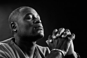 Devout African-American man praying fervently in black-and-white