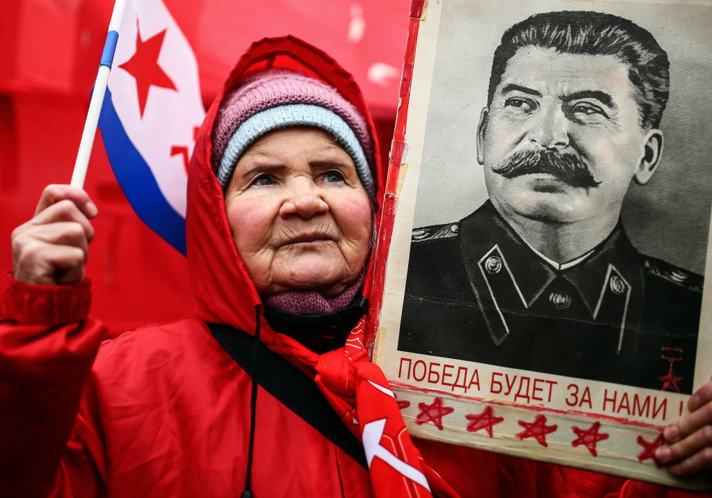 TOPSHOTS A Russian Communist holds up a portrait of former Soviet dictator Josef Staline during a rally marking "Defender of the Fatherland Day" in Moscow on February 23, 2014. AFP PHOTO/ MIKHAIL LISTOPADOV