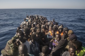 Refugees and migrants from different African countries wait to be assisted by an NGO aboard an overcrowded rubber boat, about 20 miles North of Sabratha, Libya, Saturday, March 4, 2017. A rescue ship belonging to a Spanish NGO has saved 250 migrants in danger of capsizing near the Libyan coast on Saturday. Proactiva Open Arms spokesperson Laura Lanuza says that the NGO's boat rescued the African migrants from two small rubber vessels that were at risk of being overwhelmed by the sea. (AP Photo/Santi Palacios)