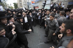 Hundreds of Ultra orthodox Jewish clash with Israeli police during a protest in Jerusalem on April 10, 2014, following the arrest of a haredi draft-dodger and against  a bill intended to enforce the haredi enlistment into the IDF (Israel Defense Force). Photo by Yonatan Sindel/Flash90