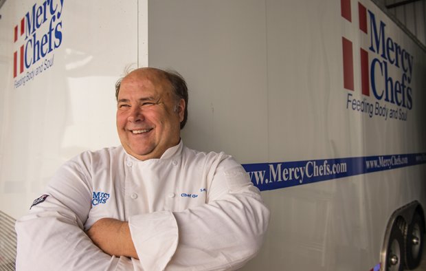 The Joy of Cooking - Gary LeBlanc in front of one of Mercy Chefs' mobile kitchens