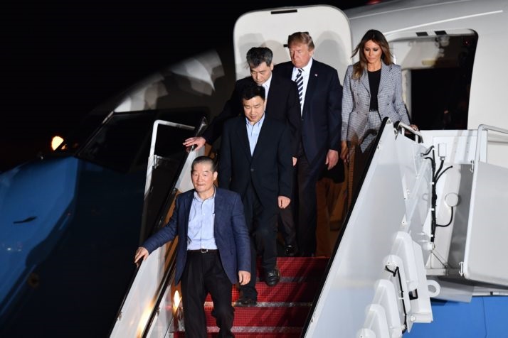 US President Donald Trump (2nd R) and his wife Melania Trump (R) walk down the stairs with US detainees Tony Kim (2nd L), Kim Dong-chul (bottom L) and Kim Hak-song (C) upon their return after they were freed by North Korea, at Joint Base Andrews in Maryland on May 10, 2018. - US President Donald Trump greeted the three US citizens released by North Korea at the air base near Washington early on May 10, underscoring a much needed diplomatic win and a stepping stone to a historic summit with Kim Jong Un. (Photo by Nicholas Kamm / AFP)        (Photo credit should read NICHOLAS KAMM/AFP/Getty Images)
